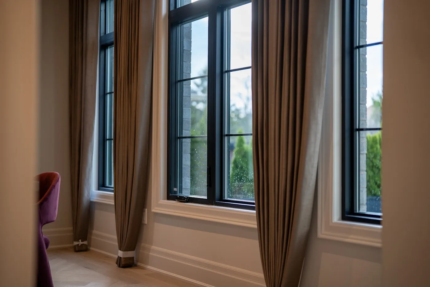 Floor-length drapes framing a tall window in an elegant living room