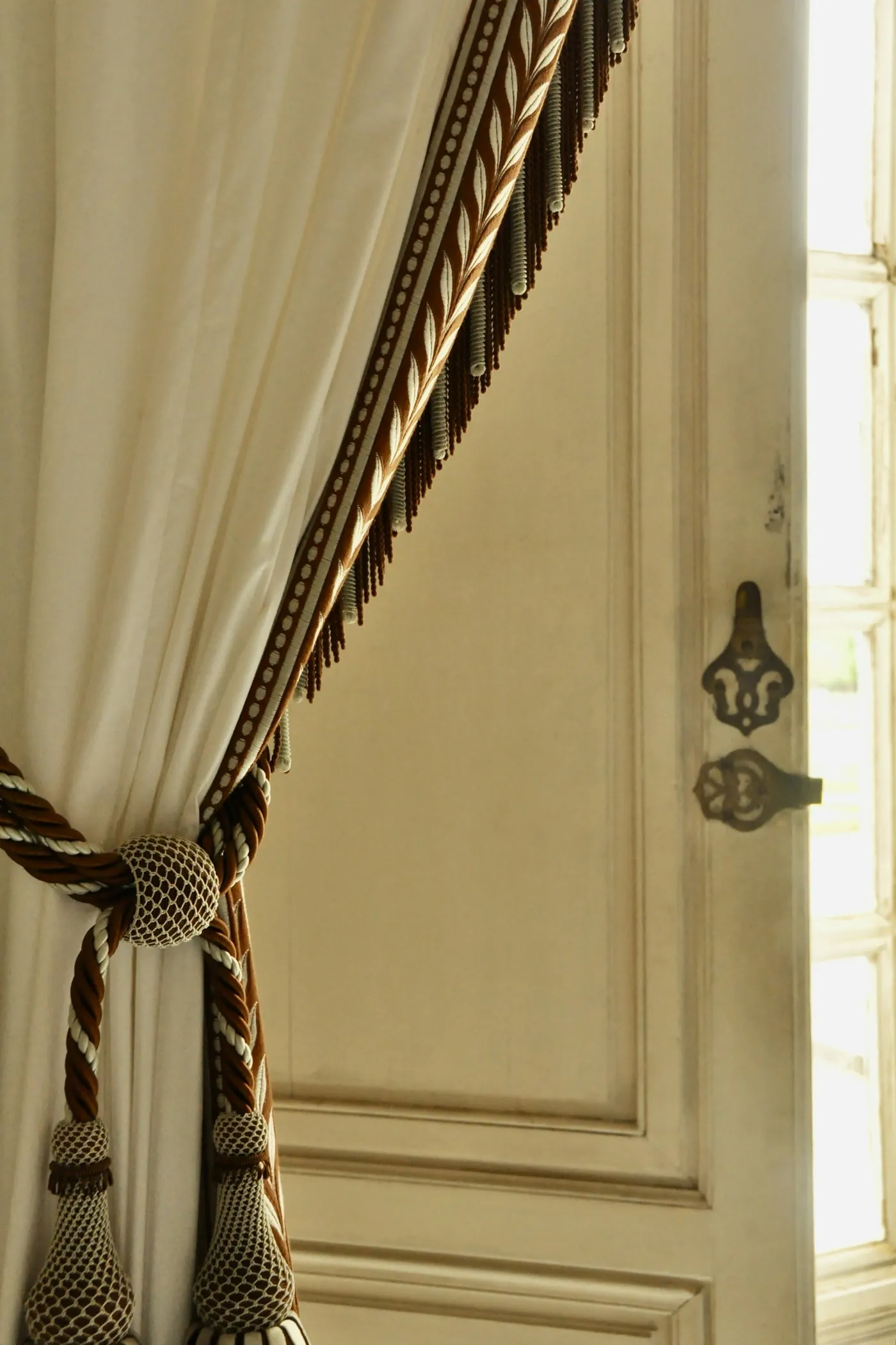 Close-up of a draped curtain with a tassel tie-back