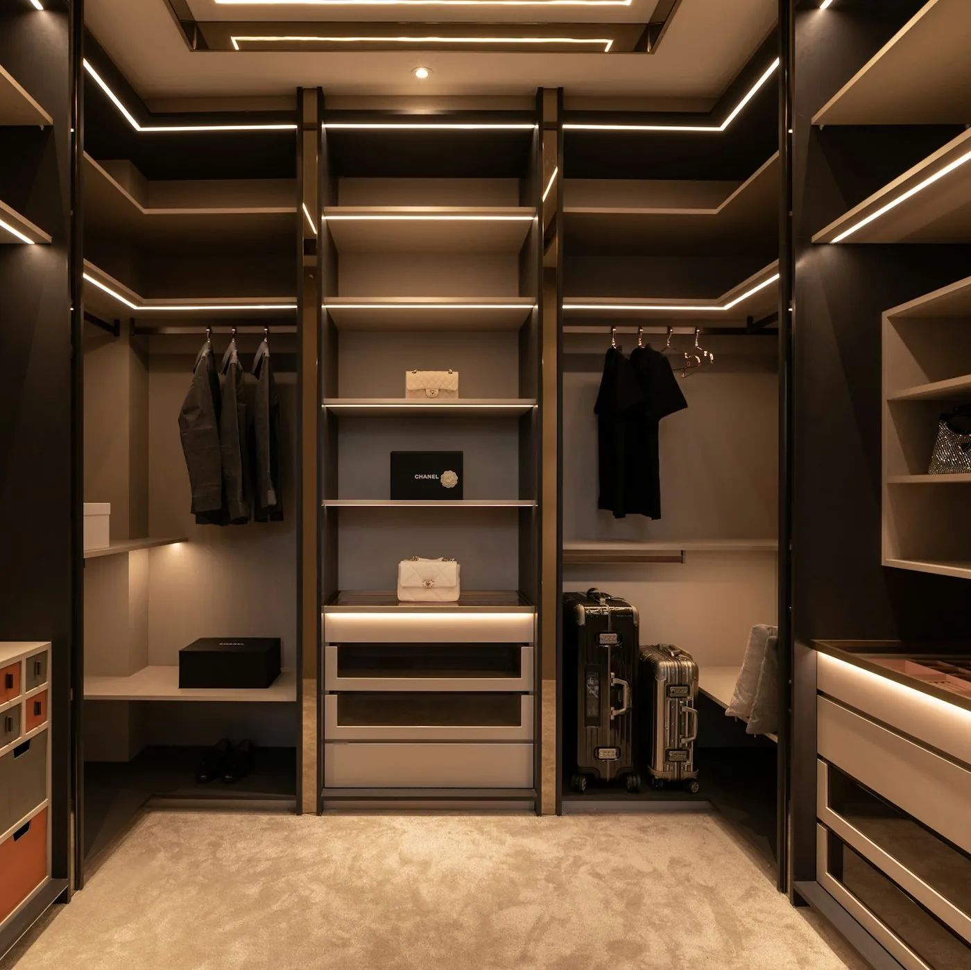 Dark walk-in wardrobe with LED-lit shelving