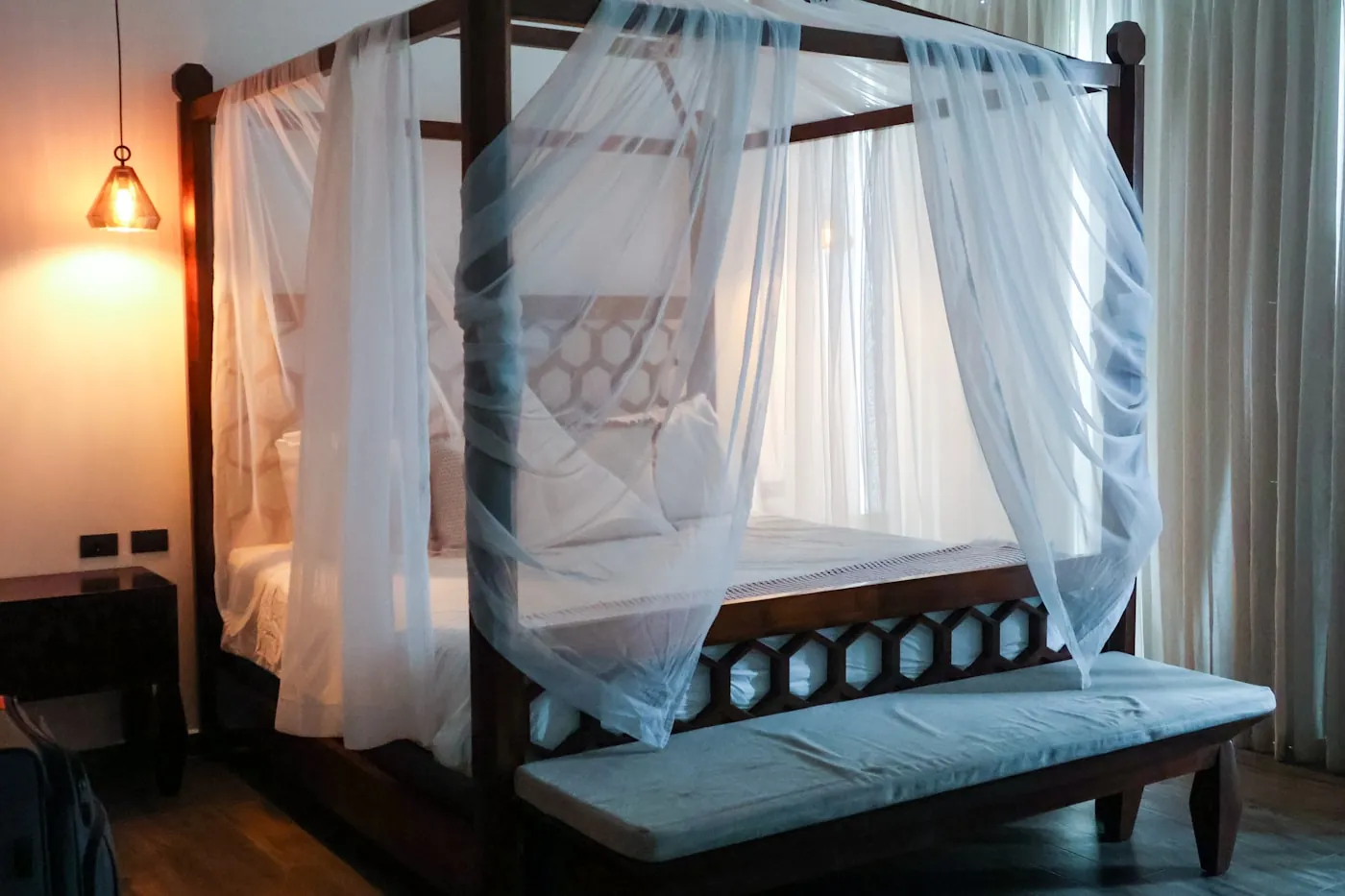 Bedroom with a sheer canopy net over the bed